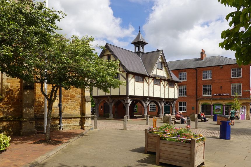 The Old Grammar School next to St Dionysius Church, Church Square, Market Harborough, Leicestershire, England, UK - this historic listed building in the town centre was built in the  seventeenth century. The ground floor is open, creating a covered market area.