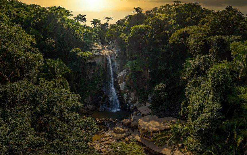 A panoramic view of Yelapa waterfall surrounded by lush tropical forest in the small Mexican village on the Pacific coast near Puerto Vallarta