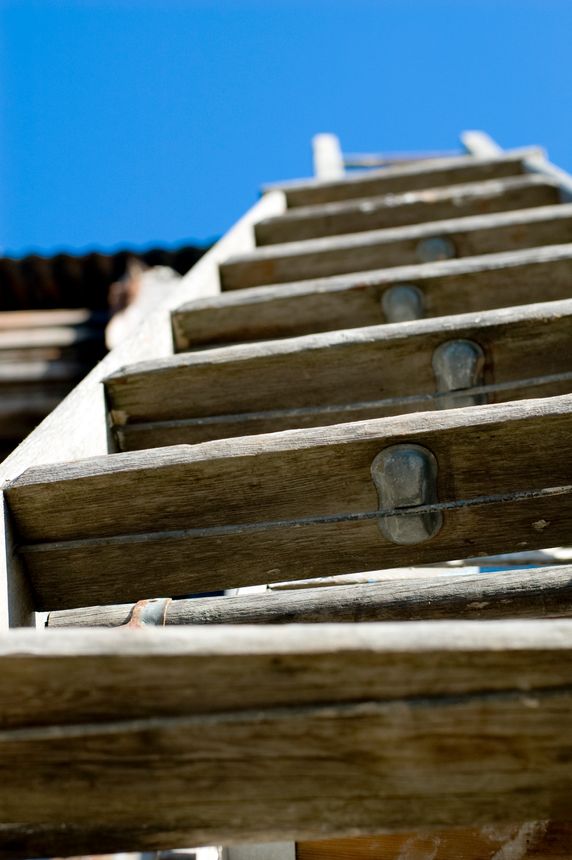 Image of a wooden ladder running toward the sky.  Evokes emotions of ascension and movement.  Taken with a Nikon DSLR using a Nikkor 50mm f/1.4D lens.