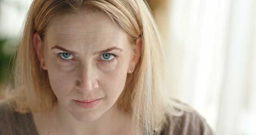 The cruel and nervous look of an evil woman and evil words in the camera.